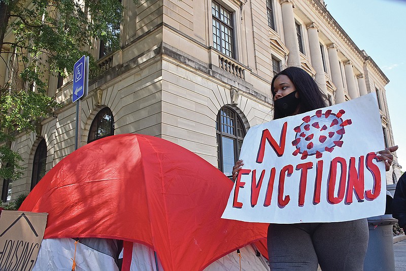 Alexis Palmer walks around a tent setup during a protest against evictions for non-payment of rent Thursday, Oct. 1, 2020 outside the Pulaski County Courthouse in Little Rock.
(Arkansas Democrat-Gazette/Staci Vandagriff)