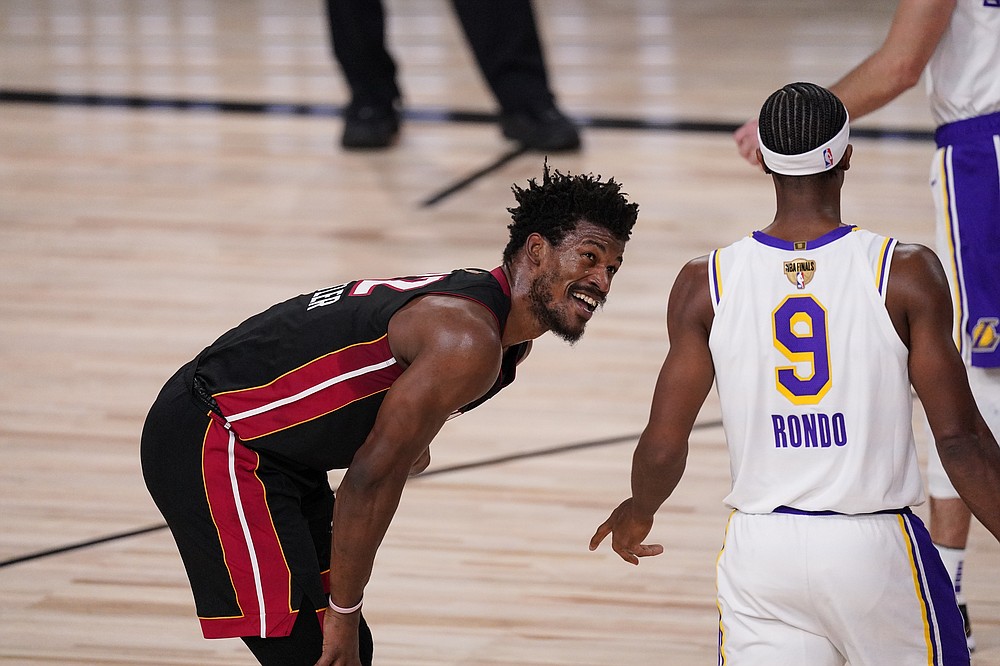Miami Heat's Jimmy Butler (22) and Los Angeles Lakers' Rajon Rondo (9) laugh during the second half in Game 3 of basketball's NBA Finals, Sunday, Oct. 4, 2020, in Lake Buena Vista, Fla. (AP Photo/Mark J. Terrill)