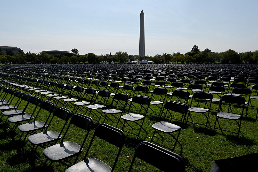 With the White House in the background, 20,000 chairs, each representing 1,000 deaths from the coronavirus pandemic in the United States are lined up on the Ellipse for a remembrance event Sunday, Oct. 4, 2020. MUST CREDIT: Washington Post photo by Katherine Frey