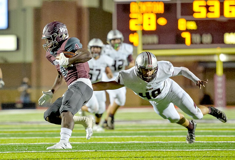 Jimmy Jones/Special to the Herald-Leader
Benton wide receiver Andre Lane (4) pulls away from Siloam Springs linebacker Caden McHaney (right) during Friday night's game at Panther stadium in Benton. Siloam Springs is back in action at home Friday against Greenwood.