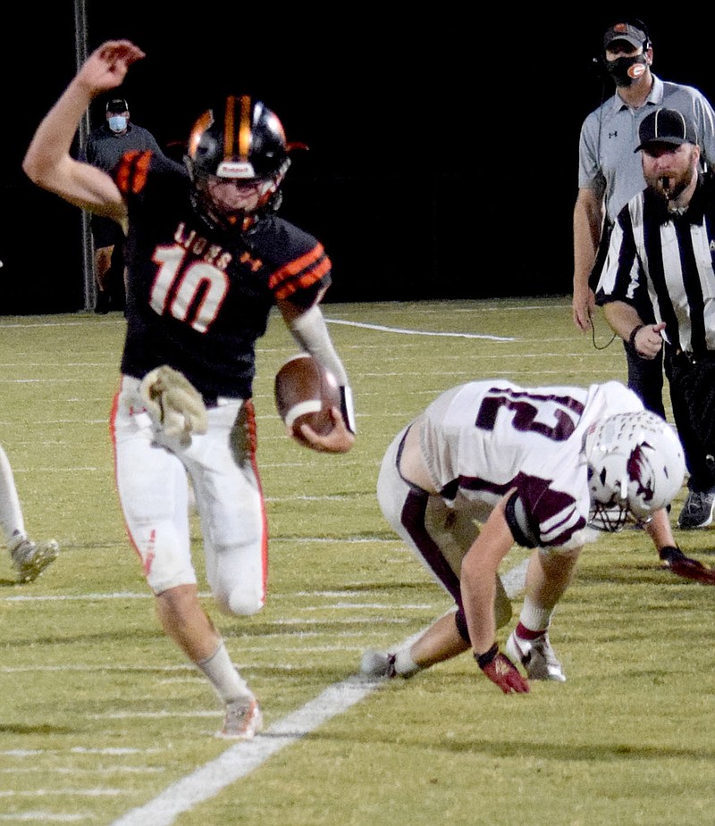 Westside Eagle Observer/MIKE ECKELS

After slipping a tackle by Eagle cornerback Gus Comer (12), Lion quarterback Cy Hilger skirts the sideline in an attempt to stay inbound during the Gravette Lions 2020 Homecoming at Lion Stadium Friday night. The Huntsville Eagles took the conference win by two points.