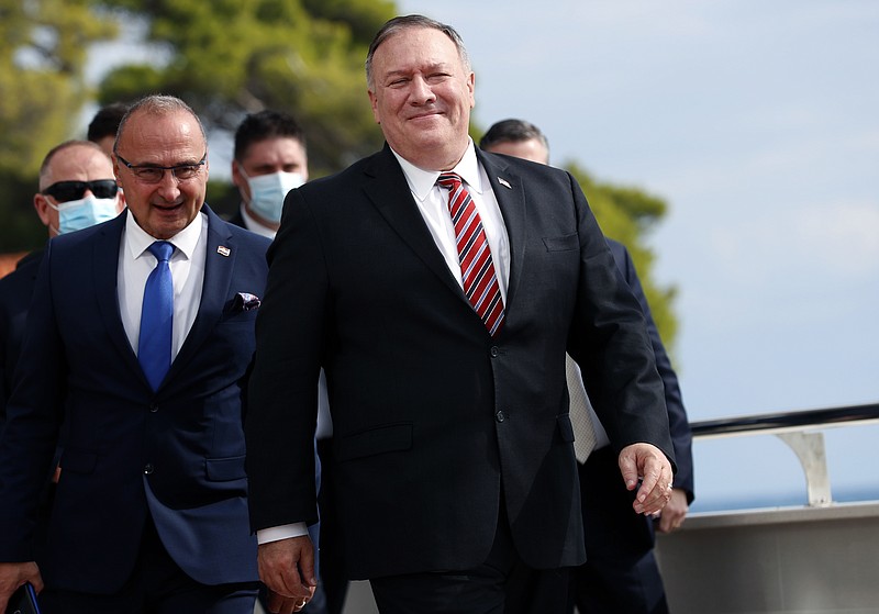 FILE - In this Oct. 2, 2020, file photo, U.S. Secretary of State Mike Pompeo, right, with Croatia's Foreign Minister Gordan Grlic Radman, arrives for a press conference after talks in Dubrovnik, Croatia. The foreign ministers from four Indo-Pacific nations known as the Quad group will gather in Tokyo Wednesday for talks in hopes of stepping up their cooperation and take leadership in a regional initiative to counter China’s growing assertiveness and influence. On his way to Tokyo, Pompeo told traveling reporters that the four countries have been preparing and hoped to have some “significant achievements” at the meeting, but he did not elaborate. (AP Photo/Darko Bandic, File) story.lead_photo.caption