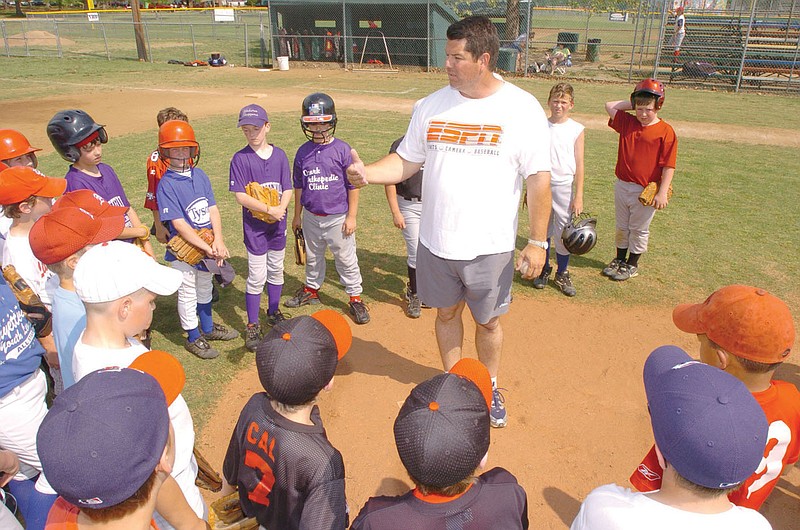 ANDY SHUPE Northwest Arkansas Times
Former Arkansas and St. Louis Cardinals standout Tom Pagnozzi speaks to members of competitive 9- and 10-year-old baseball teams the Hogs and the Razorbacks while hosting an instructional clinic for the two first-year teams Sunday at Henry Walker Park in Fayetteville.