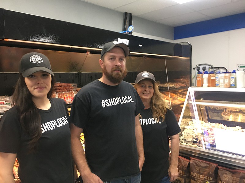 Joey Coleman, owner of White Hall Fresh Market, center, said his operation on Sheridan Road is a family affair. His sister, Jacey Coleman, left, keeps the seafood showcase filled, while his mother, Jeannie Coleman, keeps the salad bar fresh and full. (Special to The Commercial/Deborah Horn)