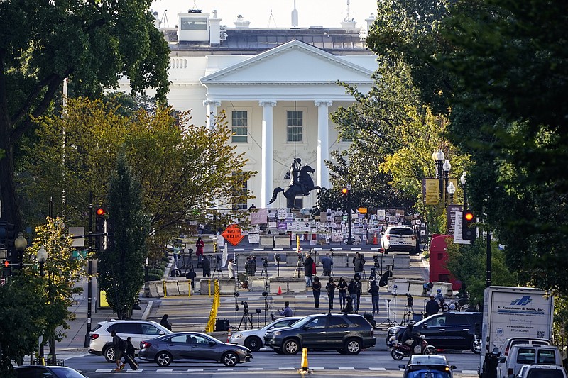 The White House is seen in Washington, early Tuesday, Oct. 6, 2020, the morning after President Donald Trump returned from the hospital where he was treated for COVID-19. Traffic moves along K Street NW as TV crews set up in Black Lives Matter Plaza. (AP Photo/J. Scott Applewhite) story.lead_photo.caption