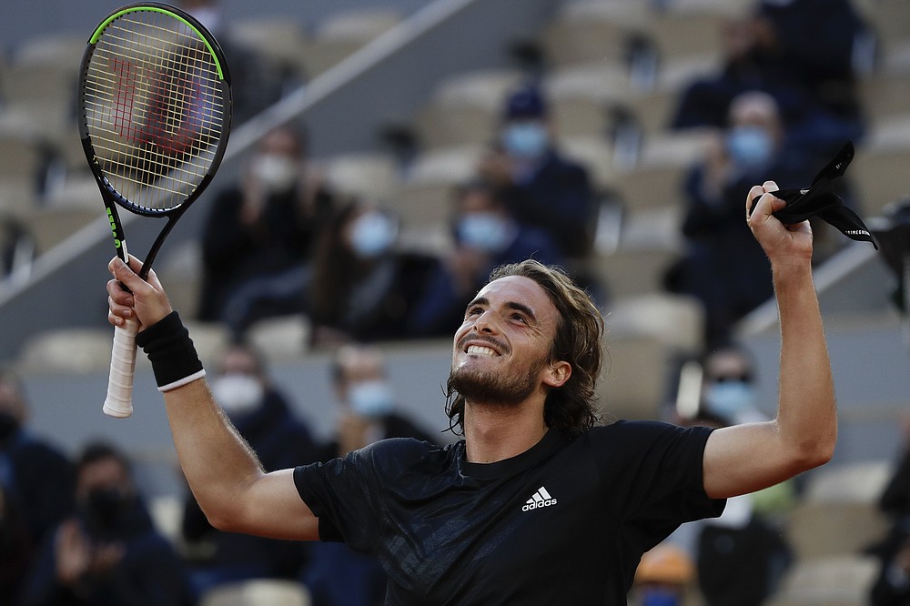 Greece's Stefanos Tsitsipas celebrates winning his quarterfinal match of the French Open tennis tournament against Russia's Andrey Rublev in three sets, 7-5, 6-2, 6-3, at the Roland Garros stadium in Paris, France, Wednesday, Oct. 7, 2020. (AP Photo/Alessandra Tarantino)