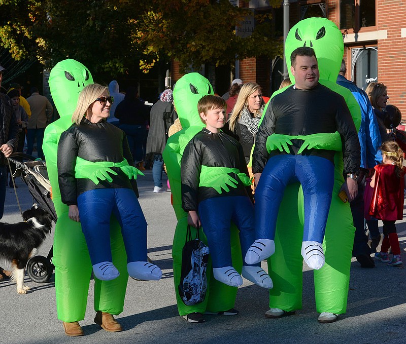 NWA Democrat-Gazette/ANDY SHUPE
Courtney Cline (from left), Dax Ledbetter and his father Drew Ledbetter, all of Fayetteville, sport Halloween costumes Thursday, Oct. 31, 2019, while enjoying the 18th Annual Trick-or-Treat on the Square hosted by Experience Fayetteville on the Fayetteville square. Businesses on the square join city departments in handing out candy to trick-or-treaters. Visit nwadg.com/photos to see more photographs from the evening.