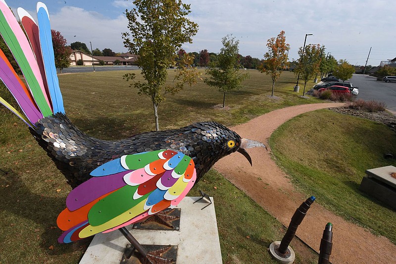 A 14-foot tall steel and aluminum mockingbird sculpture called The Incredible Electric Technicolor Mockingbird overlooks Thursday Oct. 8. 2020 the site of an outdoor play space and new parking deck that is planned for an area near the Amazeum and Crystal Bridges Museum of American Art in Bentonville. Visit nwaonline.com/201008Daily/ for more photos. (NWA Democrat-Gazette/J.T.WAMPLER)