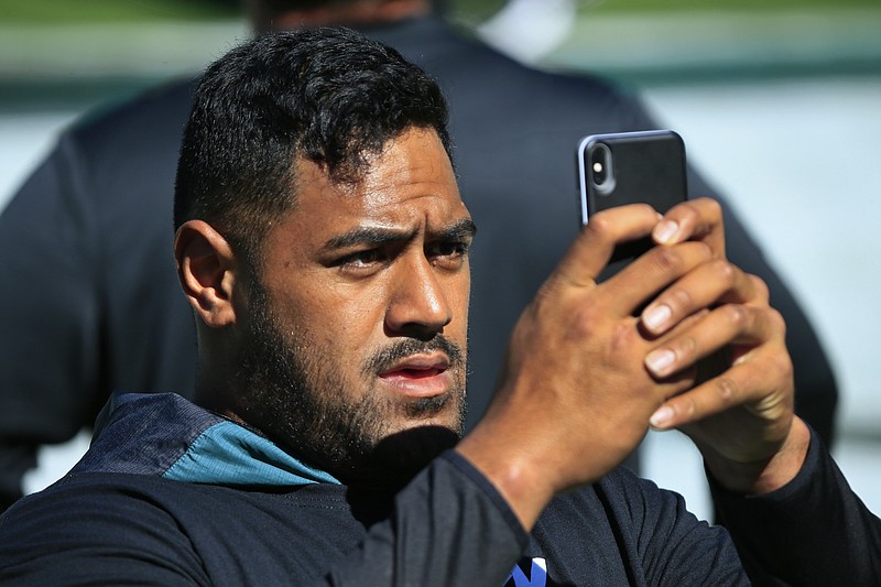 Philadelphia Eagles offensive tackle Jordan Mailata (68) takes a photo during warmups before an NFL football game against the Los Angeles Rams Sunday, Sept. 20, 2020, in Philadelphia. Mailata knew "peanuts" about the NFL when he decided to stop playing rugby in Australia and pursue a career in football only three years ago. (AP Photo/Corey Perrine, File)