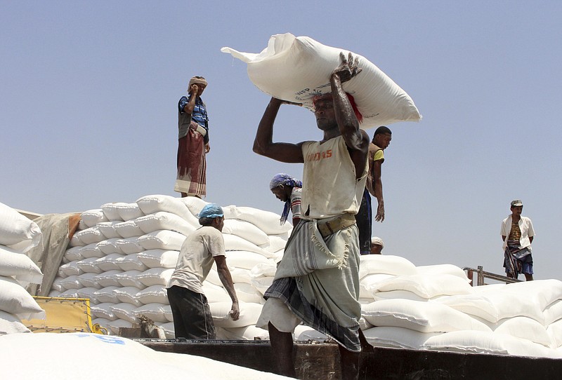 FILE - In this Sept. 21, 2018, file photo, men deliver U.N. World Food Program (WFP) aid in Aslam, Hajjah, Yemen. The World Food Program on Friday won the 2020 Nobel Peace Prize for its efforts to combat hunger and food insecurity around the globe. - AP Photo/Hammadi Issa