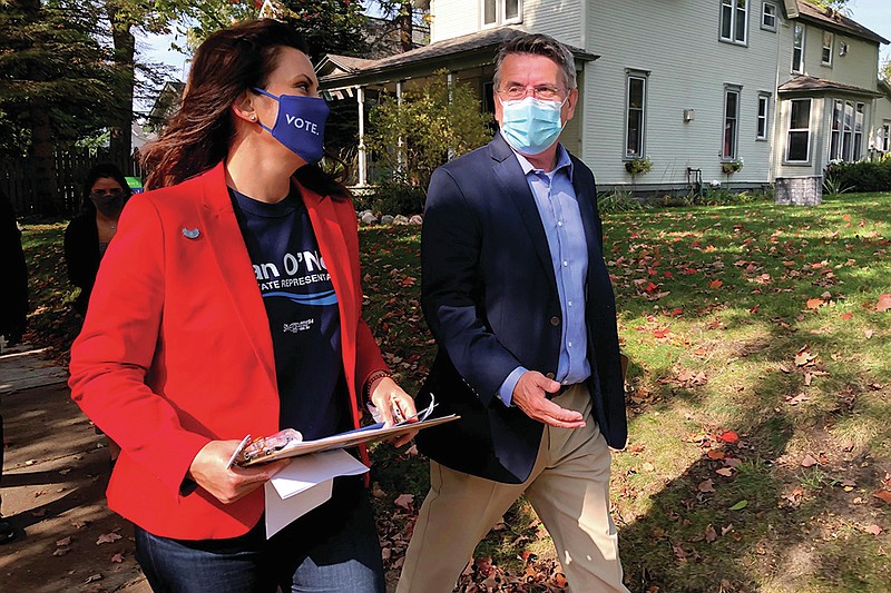 Michigan Gov. Gretchen Whitmer campaigns with Dan O'Neil, a Democratic candidate for the Michigan House in Traverse City, Mich., Friday, Oct. 9, 2020. Whitmer visited the area the day after police announced a foiled plot to kidnap the governor. (AP Photo/John Flesher)
