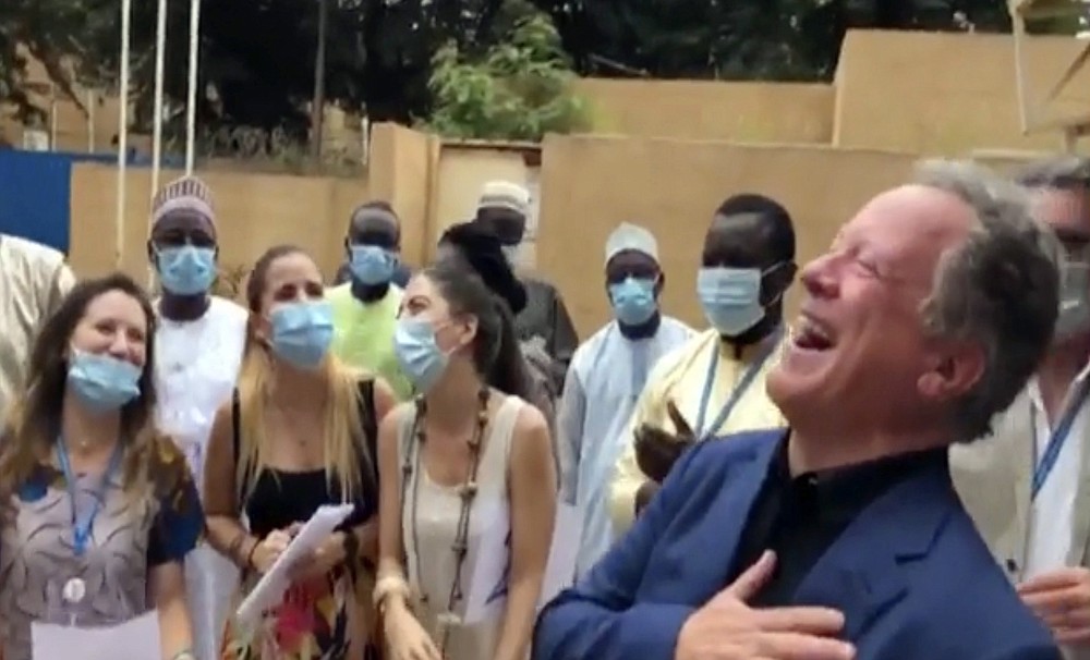 In this image taken from WFP video, David Beasley, Executive director of the World Food Program (WFP), center, celebrates with members of WFP staff in Niamey, Niger, Friday Oct. 9, 2020, after being awarded the 2020 Nobel Peace prize. The World Food Program has won the 2020 Nobel Peace Prize for its efforts to combat hunger and food insecurity around the globe. The announcement was made Friday in Oslo by Berit Reiss-Andersen, the chair of the Nobel Committee. (WFP via AP)