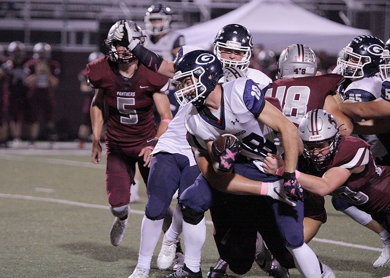 Greenwood Bulldog Cameron Krone (18) fight for yardage against Siloam Springs' Tyler Johnson (28) Friday, October 9, 2020, at Panther Stadium, Siloam Springs, Arkansas (Special to NWA Democrat-Gazette/Brent Soule)