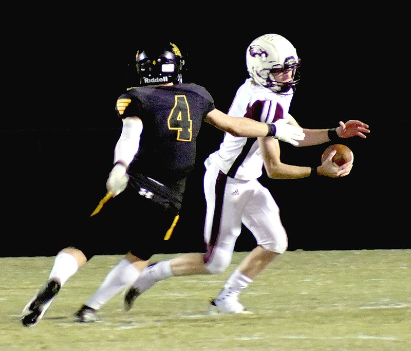 MARK HUMPHREY  ENTERPRISE-LEADER/Prairie Grove senior defensive end Caden Redfern chases Huntsville quarterback Brooks Wiggins out of the pocket. The Tigers routed the Eagles, 55-14, in Friday's 4A-1 gridiron contest.