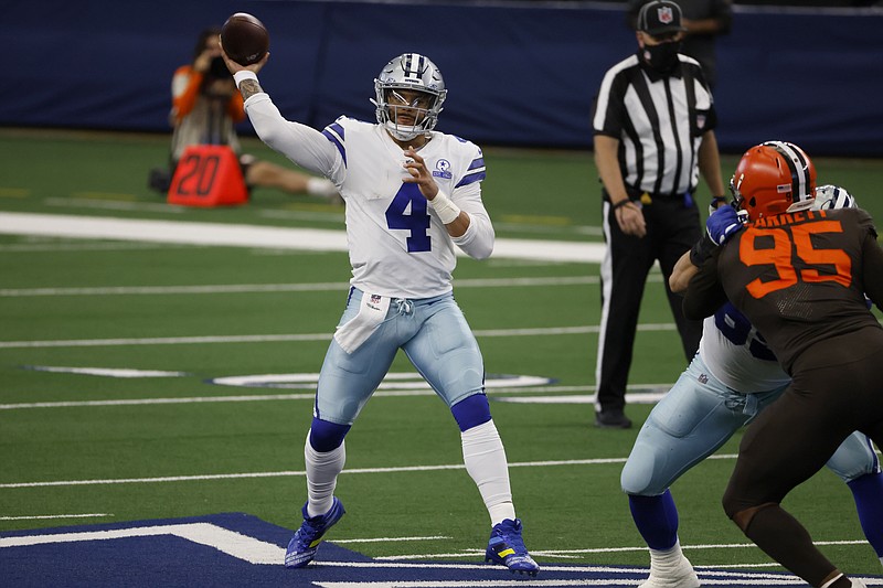 Dallas Cowboys quarterback Dak Prescott (4) throws a pass under pressure from Cleveland Browns defensive end Myles Garrett (95) in the second half of an NFL football game in Arlington, Texas, Sunday, Oct. 4, 2020. (AP Photo/Ron Jenkins)