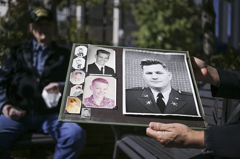 Reyna Maloy holds up an old picture of Albert King, Friday, October 2, 2020 at the Fayetteville Square in Fayetteville. Check out nwaonline.com/2010010Daily/ for today's photo gallery. 
(NWA Democrat-Gazette/Charlie Kaijo)