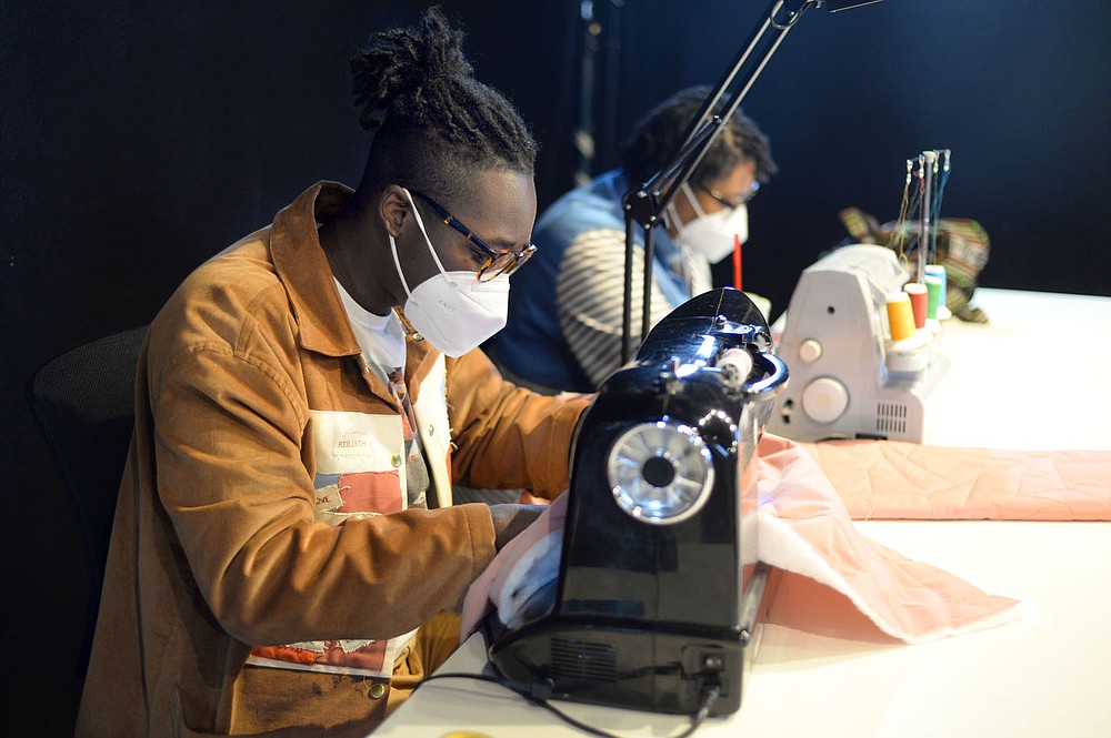 Fashion designer Bruce Davis works alongside his wife, Keinona Davis, Saturday, Oct. 10, 2020, as they begin their term as resident artists in the Arkansas Arts and Fashion Forum's Emerge program at the Creative Arkansas Community Hub & Exchange, formerly Arts Center of the Ozarks, in Springdale. The group is working to create an artist residency to connect local talent with national and international leaders in apparel and fashion design. Visit nwaonline.com/201011Daily/ for today's photo gallery.
(NWA Democrat-Gazette/Andy Shupe)