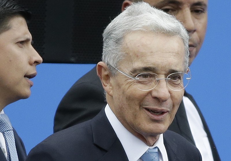 FILE - In this Aug. 7, 2018 file photo, Colombia's former President and Senator Alvaro Uribe arrives to the inauguration ceremony for Colombia's new president Ivan Duque in Bogota, Colombia.   Uribe has been ordered freed from house arrest while he is investigated for possible witness tampering. A judge ordered Uribe’s release Saturday, Oct. 10, 2020,  in a case that has divided the South American nation and exposed lingering tensions over Colombia’s peace accord for ending a half-century conflict with leftist guerrillas.  (AP Photo/Fernando Vergara, File)