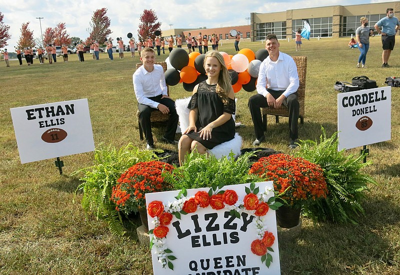 Westside Eagle Observer/SUSAN HOLLAND
Homecoming queen candidate Lizzy Ellis poses with her escorts Ethan Ellis and Cordell Donell during the 2020 homecoming parade Friday afternoon at Gravette High School. Ellis and other members of the homecoming court participated in the event.