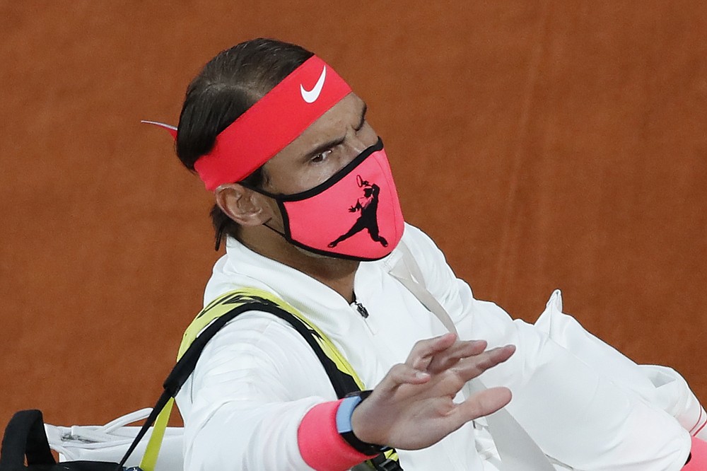 Spain's Rafael Nadal wears a face mask as he walks onto the court for the final match of the French Open tennis tournament against Serbia's Novak Djokovic at the Roland Garros stadium in Paris, France, Sunday, Oct. 11, 2020. (AP Photo/Alessandra Tarantino)