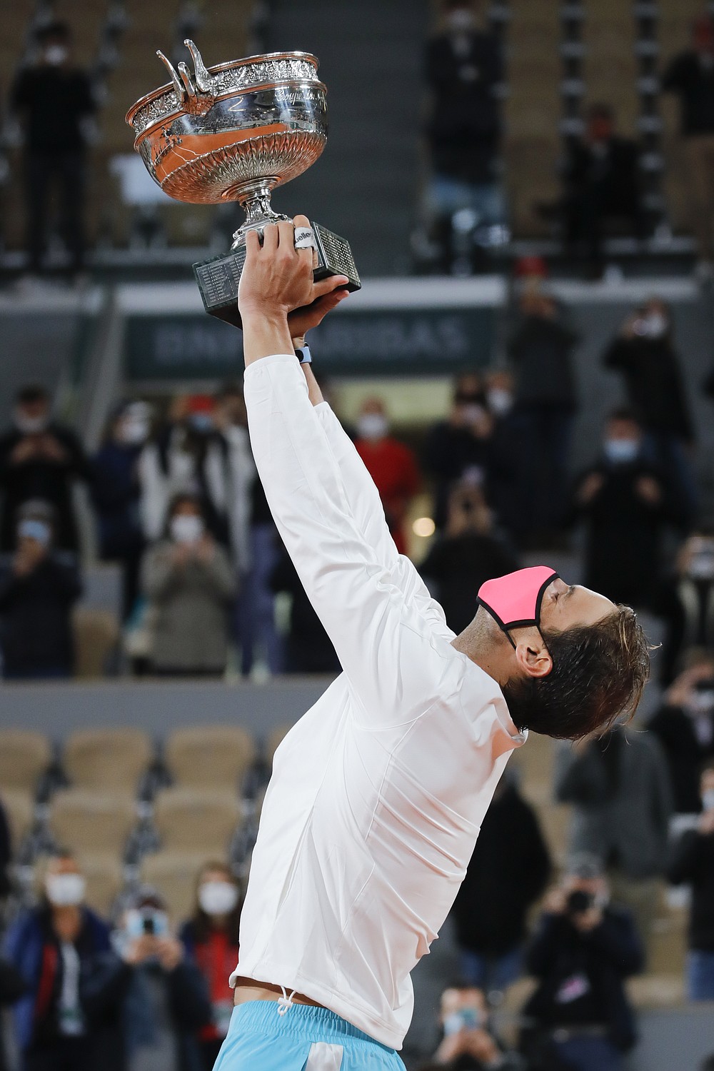 Spain's Rafael Nadal holds the trophy as he celebrates winning the final match of the French Open tennis tournament against Serbia's Novak Djokovic in three sets, 6-0, 6-2, 7-5, at the Roland Garros stadium in Paris, France, Sunday, Oct. 11, 2020. (AP Photo/Christophe Ena)