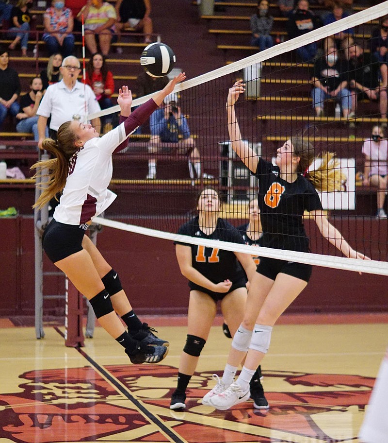 Westside Eagle Observer/RANDY MOLL
Gentry's Madison Voyles battles at the net with Gravette's Jayden Reems, with Sophie Bass in the background, during Thursday's rivalry match in Gentry.