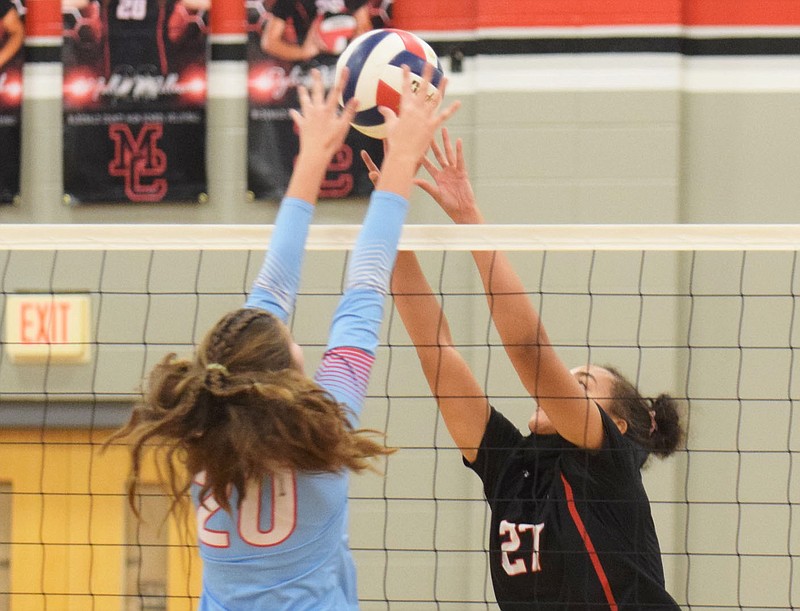 RICK PECK/SPECIAL TO MCDONALD COUNTY PRESS McDonald County's Shye Hardin goes up to block a hit by Webb City's Kate Brownfield (20) during the Lady Mustangs' 24-26, 21-25, 22-25 loss on Oct. 12 at MCHS.