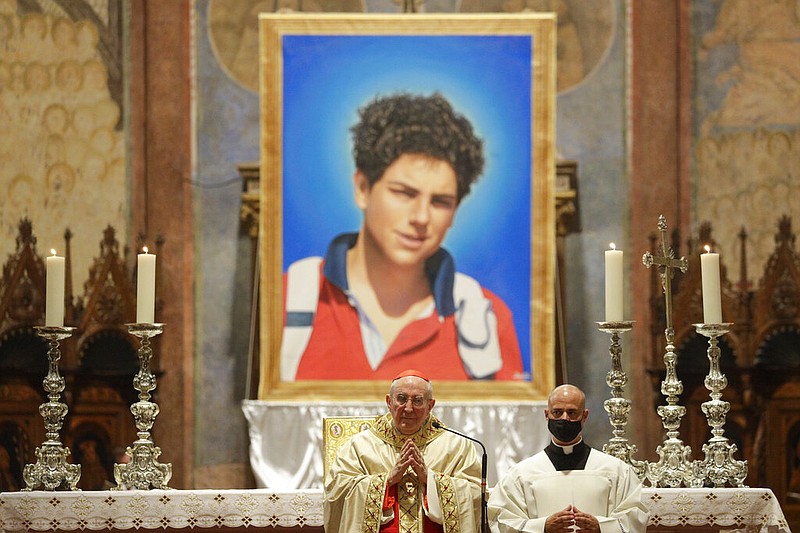 An image of 15-year-old Carlo Acutis, an Italian boy who died in 2006 of leukemia, is seen during his beatification ceremony Oct. 10, celebrated by Cardinal Agostino Vallini (center) in the St. Francis Basilica, in Assisi, Italy.
(AP/Gregorio Borgia)