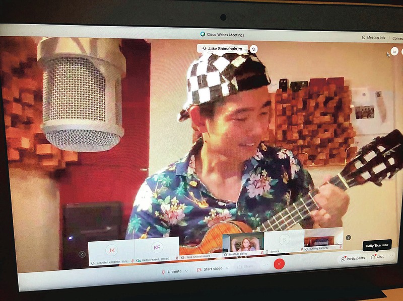 This Friday, Sept. 25, 2020, photo of a computer screen in Honolulu shows internationally renowned ukulele virtuoso performing at a virtual concert organized by the principal of a small Hawaii school. Aikahi Elementary Principal Keoki Fraser is using local star power to help his school community feel connected and uplifted during the uncertainties of the pandemic. (AP Photo/Jennifer Sinco Kelleher)