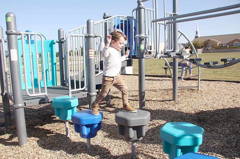 LYNN KUTTER ENTERPRISE-LEADER
Max McKinney, 3, of Prairie Grove, plays on the new playground next to Prairie Grove Public Library. He was there with his older sister and mother.