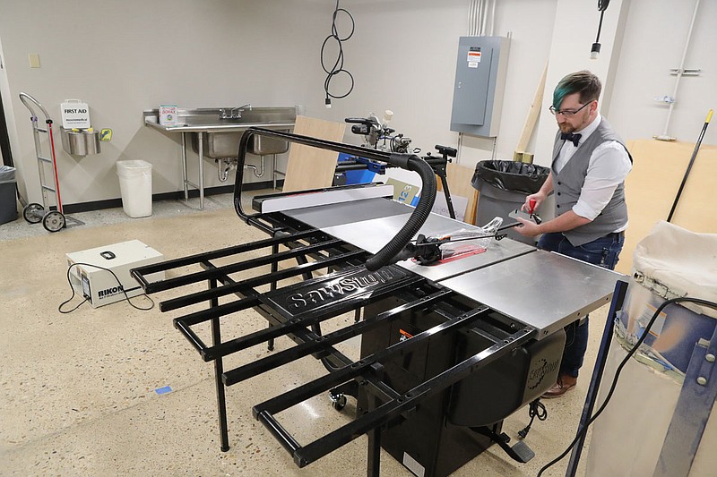 NPC makerspace coordinator Michael Karr adjusts a saw blade at the school’s new location on the college campus Thursday. - Photo by Richard Rasmussen of The Sentinel-Record