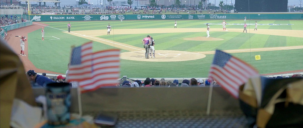 A 2019 game of Tecolotes de los Dos Laredo, a binational professional baseball team with home stadiums in Nuevo Laredo, Mexico, and Laredo, Texas, appears in a scene from "Bad Hombres." The new Showtime sports documentary follows this AAA Mexican League baseball team that plays on both sides of the U.S.-Mexico border amid the tension around migration, divisive politics, and environmental concerns. (Showtime via AP)