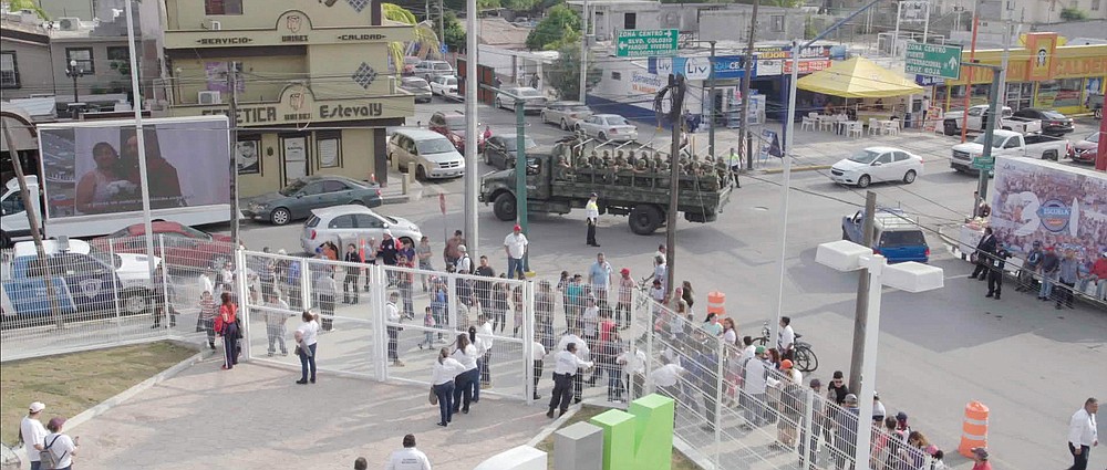 A Mexican military truck with soldiers patrol the baseball stadium in Nuevo Laredo, Mexico, during a 2019 home game of e Tecolotes de los Dos Laredo, a binational professional baseball team with home stadiums in Nuevo Laredo and Laredo, Texas. "Bad Hombres," a new Showtime sports documentary, follows this AAA Mexican League baseball team that plays on both sides of the U.S.-Mexico border amid the tension around migration, divisive politics, and environmental concerns. (Showtime via AP)