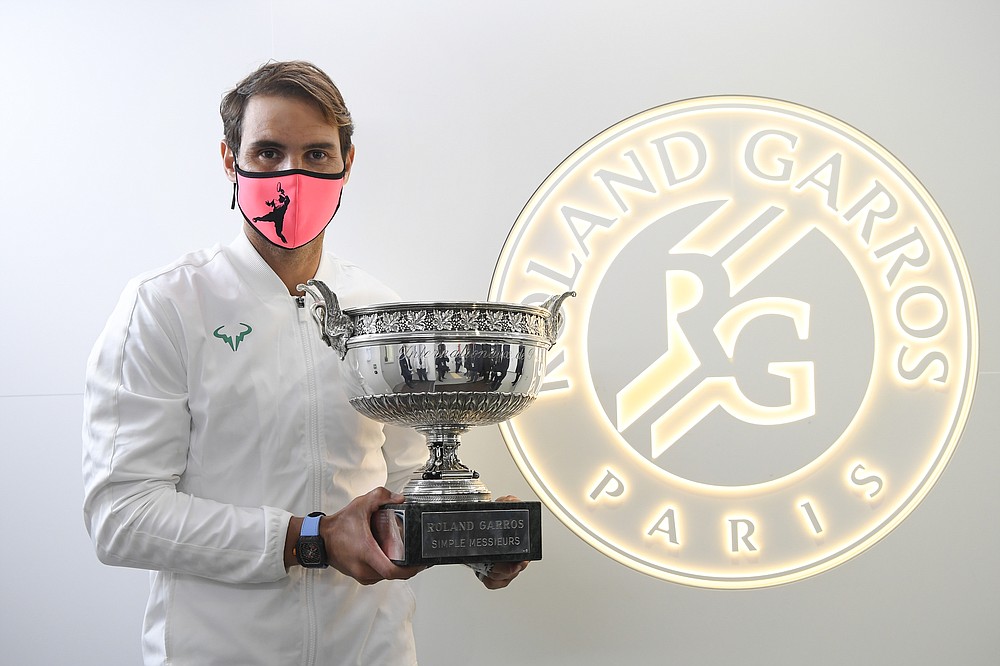 In this Sunday, Oct. 11, 2020 image provided by the French Tennis Federation FFT, Spain's Rafael Nadal poses with the trophy in the locker room after winning the final match of the French Open tennis tournament against Serbia's Novak Djokovic at the Roland Garros stadium in Paris, France. (FFT/Julien Crosnier via AP)