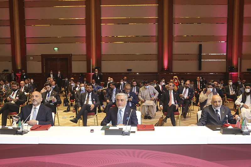 FILE - In this Sept. 12, 2020 file photo, Abdullah Abdullah, center, chairman of Afghanistan's High Council for National Reconciliation, attends the opening session of the peace talks between the Afghan government and the Taliban in Doha, Qatar.   Afghan officials say, Thursday, Oct. 15, 2020,  more than 5,600 families have fled their homes amid renewed fighting between the Taliban and government forces in southern Helmand province. The upsurge in fighting comes as Afghan government representatives and the Taliban are holding peace talks in Qatar, trying to end the war. (AP Photo/ Hussein Sayed, File)