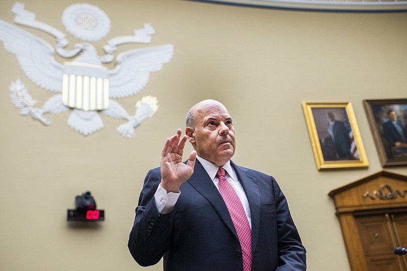 FILE - In this Monday, Aug. 24, 2020, file photo, Postmaster General Louis DeJoy is sworn in before testifying during a House Oversight and Reform Committee hearing on the Postal Service on Capitol Hill in Washington. The U.S. Postal Service agreed Wednesday, Oct. 14, to reverse changes that slowed mail service nationwide, settling a lawsuit filed by Montana Gov. Steve Bullock during a pandemic that is expected to force many more people to vote by mail. (Tom Williams/Pool Photo via AP, File)