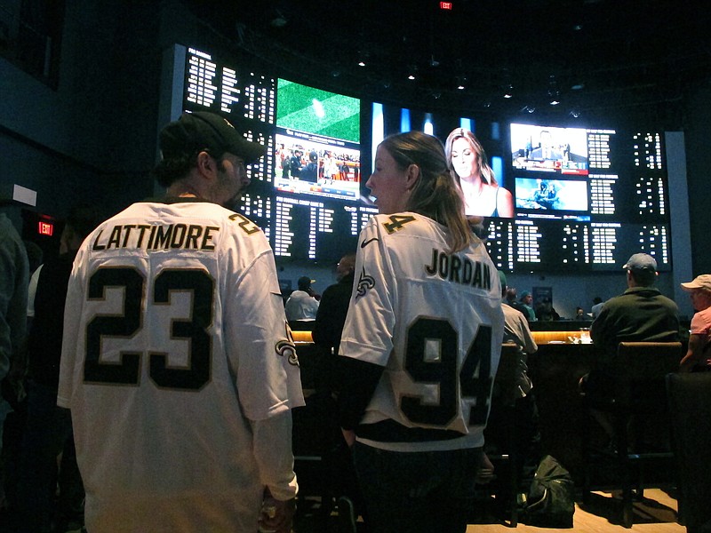 This Sept. 9, 2018 photo shows football fans waiting for kickoff in the sports betting lounge at the Ocean Casino Resort in Atlantic City, N.J. Figures released on Thursday, Oct. 15, 2020 showed New Jersey broke its own recently set U.S. record for the most money bet on sports in a single month in September when gamblers plunked down more than $748 million on sports. (AP Photo/Wayne Parry) story.lead_photo.caption