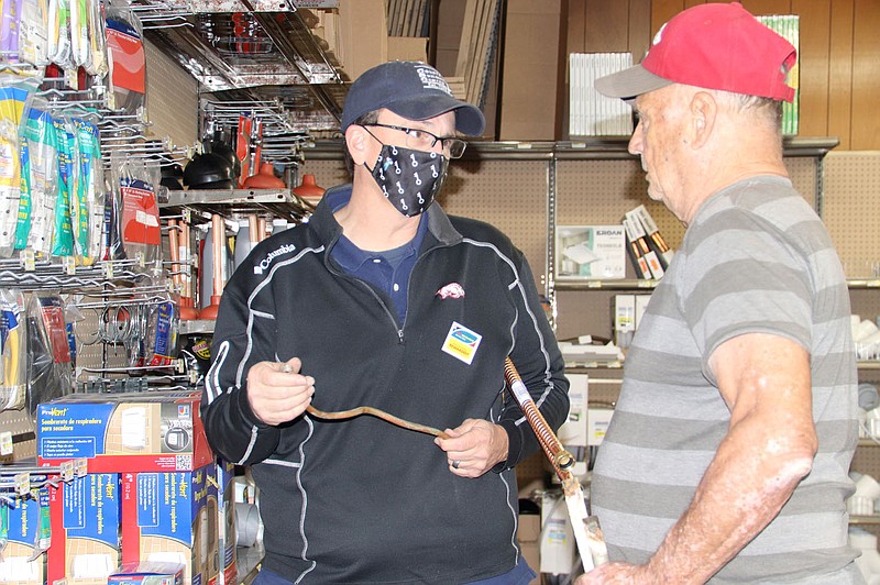 LYNN KUTTER ENTERPRISE-LEADER
Brett Reeves, manager of the new County Building Center - NWA, helps Van Reed of Lincoln during the store's grand opening celebration Friday. The store opened in June and is a building supplies center serving Northwest Arkansas.