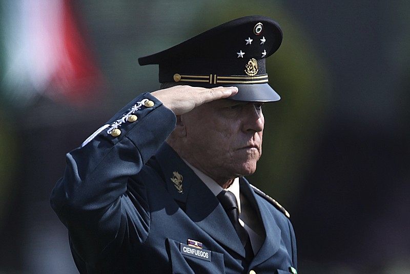 FILE - In this April 16, 2016 file photo, Mexico's Defense Secretary Gen. Salvador Cienfuegos Zepeda salutes soldiers at the Number 1 military camp in Mexico City. Mexico's Foreign Relations Secretary Marcelo Ebrard wrote in his Twitter account Thursday, Oct. 15, 2020, that U.S. Ambassador Christopher Landau had informed him that Gen. Cienfuegos has been arrested in Los Angeles. (AP Photo/Marco Ugarte, File)