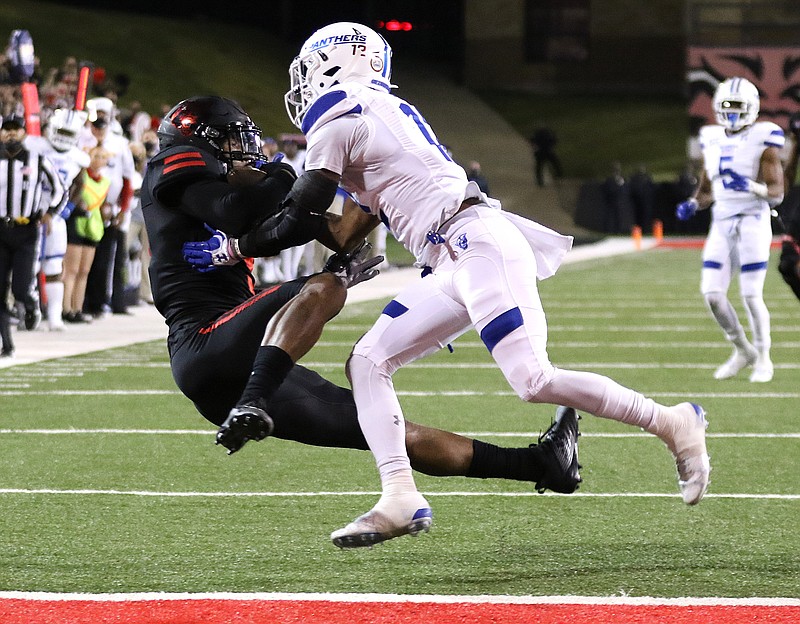 Arkansas State wide receiver Jonathan Adams, Jr. (9) pulls in a 32-yard touchdown reception while defended by Georgia State cornerback Tyler Gore (12) during the fourth quarter Thursday's 59-52 win at Centennial Bank Stadium in Jonesboro. - Photo by Thomas Metthe of Arkansas Democrat-Gazette story.lead_photo.caption