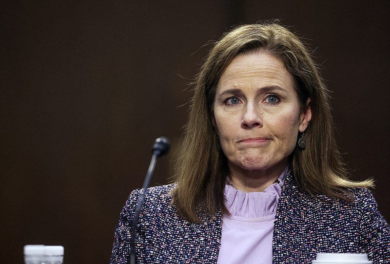 Supreme Court nominee Amy Coney Barrett departs with her husband, Jesse, after the third day of her confirmation hearings before the Senate Judiciary Committee on Capitol Hill in Washington, Wednesday. - Jonathan Ernst/Pool via AP story.lead_photo.caption