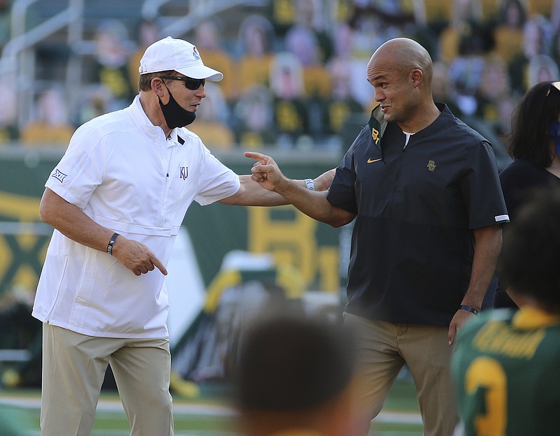 Kansas head coach Les Miles, left and Baylor head coach Dave Aranda, right, greet each other before start of a Sept. 26 NCAA football game in Waco, Texas. - Photo by Jerry Larson/Waco Tribune-Herald via The Associated Press story.lead_photo.caption