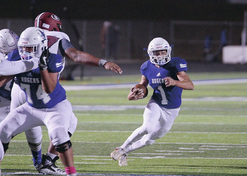 Rogers Mountaineers Senior Christian Francisco (1) scrambles out of the pocket in the game against the Springdale Bulldogs Friday, October 16, 2020, at Whitey Smith Stadium, Rogers, Arkansas (Special to NWA Democrat-Gazette/Brent Soule)