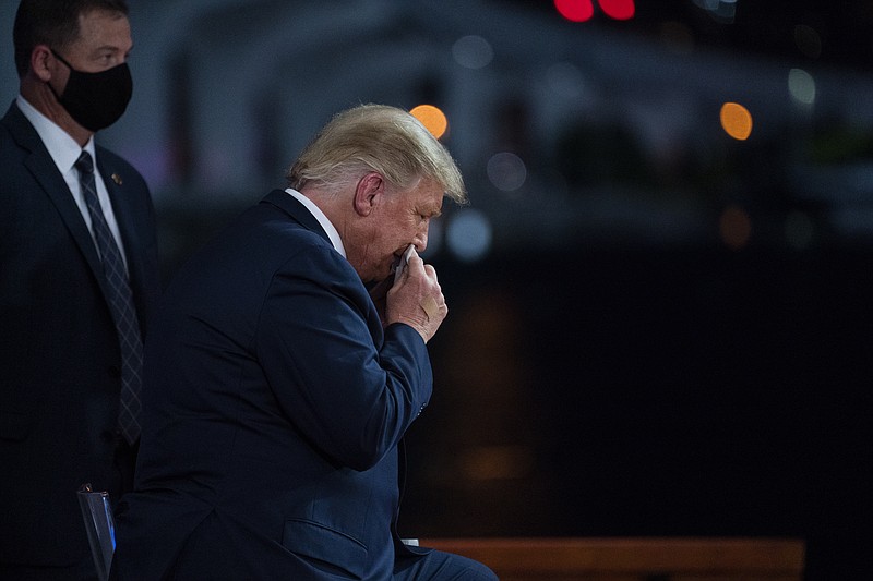 President Donald Trump wipes away sweat during an NBC News Town Hall, at Perez Art Museum Miami, Thursday, Oct. 15, 2020, in Miami. (AP Photo/Evan Vucci)