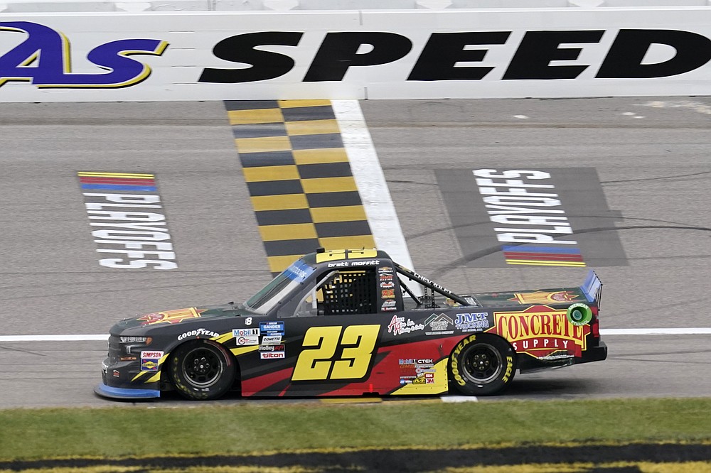 Brett Moffitt (23) crosses the finish line to win a NASCAR Truck Series auto race at Kansas Speedway in Kansas City, Kan., Saturday, Oct. 17, 2020. (AP Photo/Orlin Wagner)