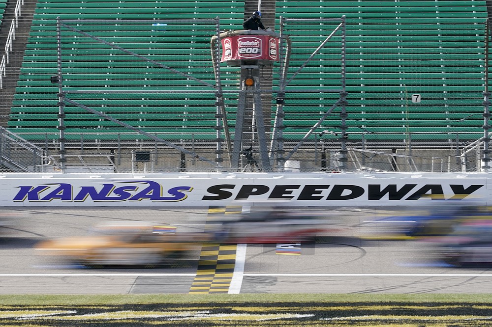 Drivers take the green flag during a NASCAR Truck Series auto race at Kansas Speedway in Kansas City, Kan., Saturday, Oct. 17, 2020. (AP Photo/Orlin Wagner)