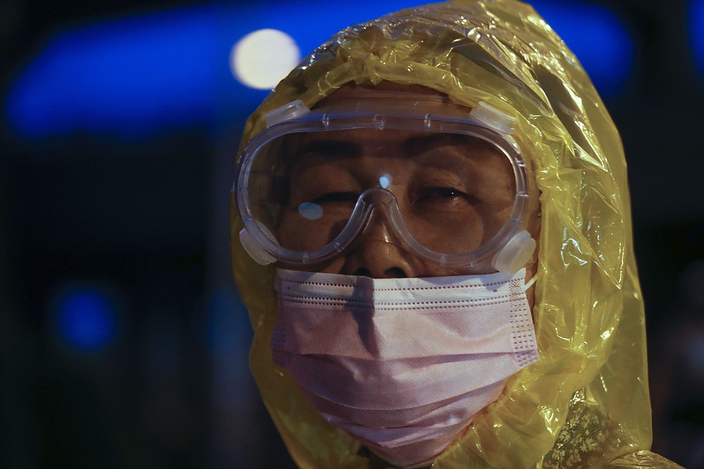 A Pro-democracy protester wearing a face mask to help curb the spread of coronavirus takes part in a protest in Bangkok, Thailand, Saturday, Oct. 17, 2020. The authorities in Bangkok shut down mass transit systems and set up roadblocks Saturday as the Thailand capital faced a fourth straight day of determined anti-government protests. (AP Photo/Sakchai Lalit)