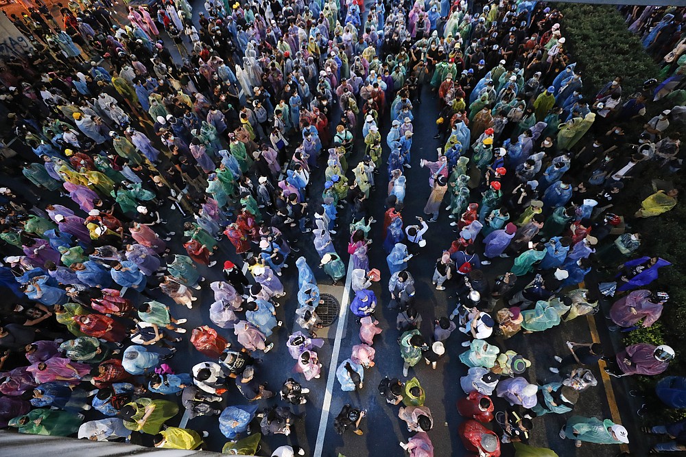 Pro-democracy protesters gather during a protest in Bangkok, Thailand, Saturday, Oct. 17, 2020. The authorities in Bangkok shut down mass transit systems and set up roadblocks Saturday as Thailand capital faced a fourth straight day of determined anti-government protests. (AP Photo/Sakchai Lalit)