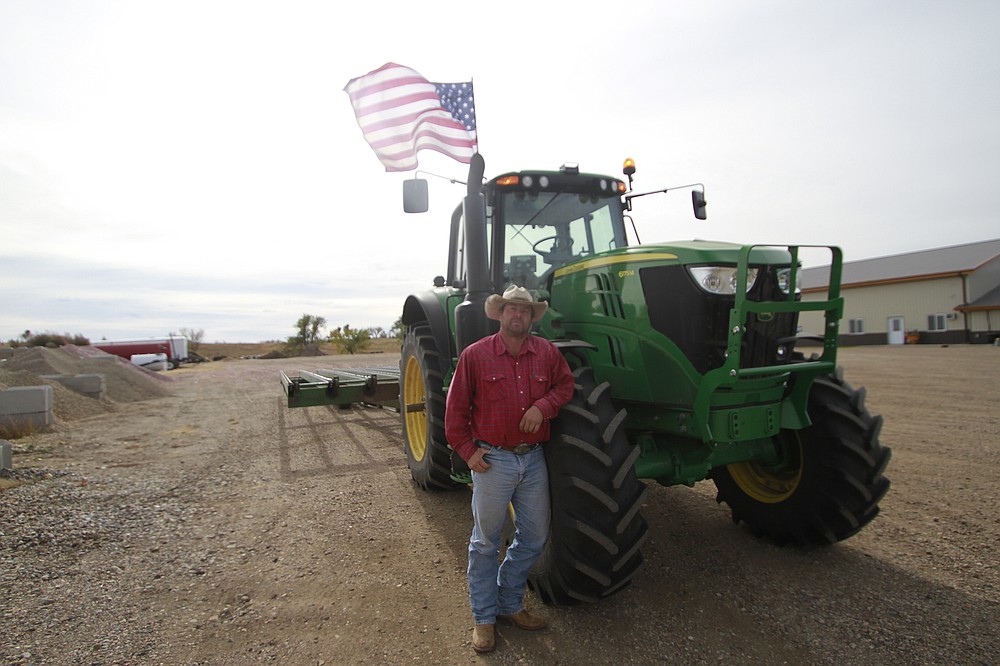 Cody Tobin poses for a photo on Friday, Oct. 16, 2020, in Wessington Springs, S.D. Tobin operates a ranch in Jerauld County, which has seen one of the nation's highest rates of coronavirus cases per person, but said he is not afraid of the virus. (AP Photo/Stephen Groves)