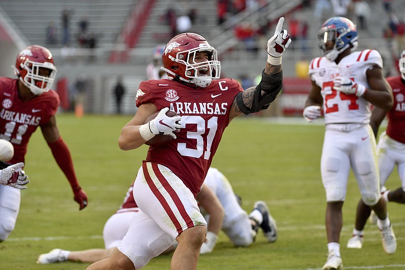 Arkansas defensive back Grant Morgan (31) celebrates as he returns an interception for a touchdown against Ole Miss during the second half of Saturday's game in Fayetteville. - Photo by Michael Woods of The Associated Press story.lead_photo.caption